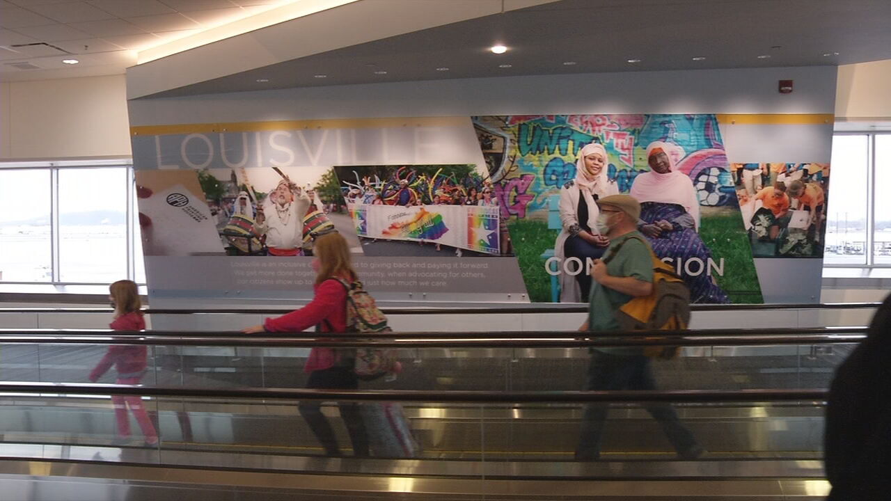 Travelers walk through the Louisville Muhammad Ali International Airport